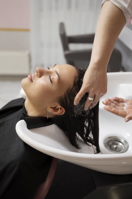 woman-getting-treatment-hairdresser-shop